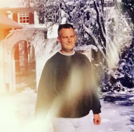 An old polaroid of Gerald Simcoe in a snowy front yard.